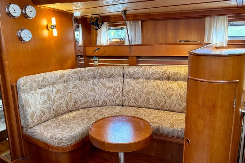 Su Ching Yacht Photos Pics Cozy interior of 1984 Tayana 55 yacht with elegant wood finish and patterned seating.