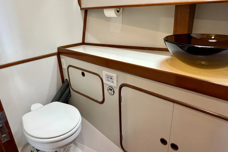Su Ching Yacht Photos Pics Bathroom interior of 1984 Tayana 55 yacht with modern sink and toilet.