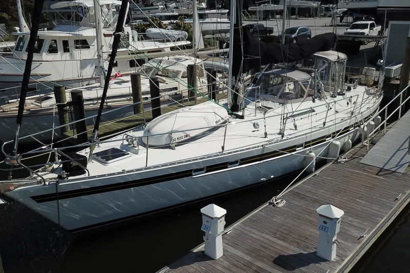 Su Ching Yacht Photos Pics 1984 Tayana 55 sailboat docked at marina, surrounded by other boats.