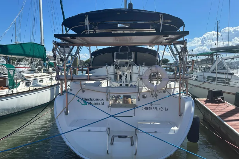 Mischievous Mermaid Yacht Photos Pics 2004 Hunter Deck Salon sailboat docked, rear view with "Mischievous Mermaid" name visible.