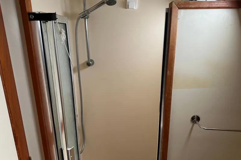Mischievous Mermaid Yacht Photos Pics Shower area in 2004 Hunter Deck Salon boat with wooden trim and sliding door.