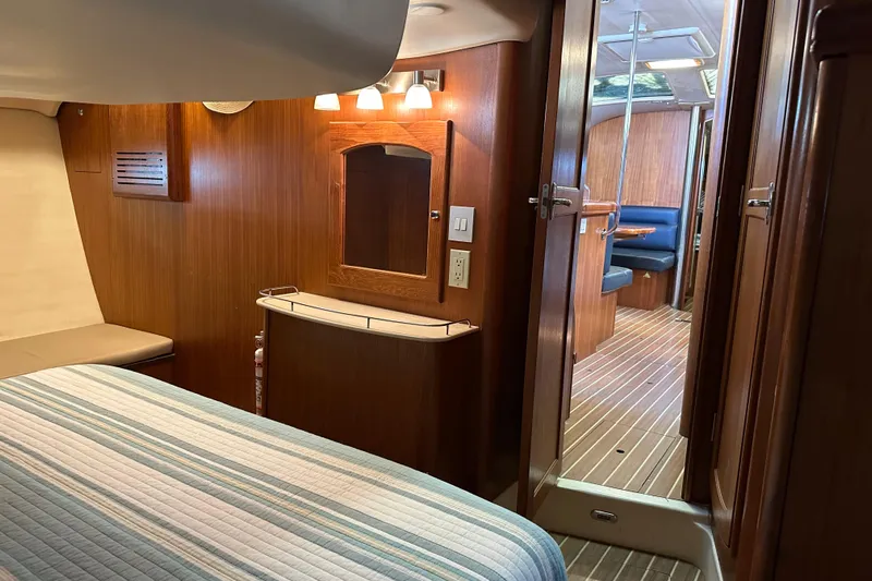 Mischievous Mermaid Yacht Photos Pics Interior of 2004 Hunter Deck Salon yacht, featuring cozy wood paneling and a comfortable cabin.