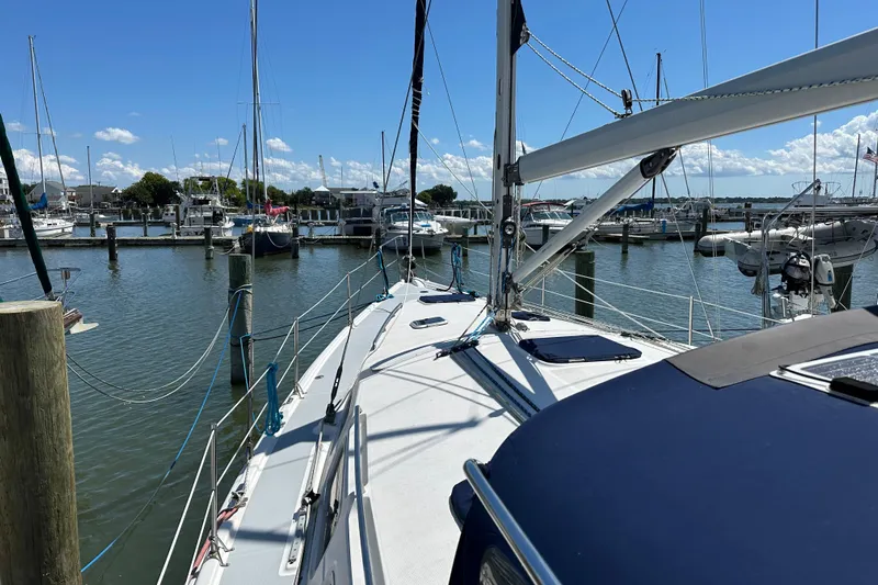 Mischievous Mermaid Yacht Photos Pics Sailboat docked at marina, Hunter Deck Salon 2004, sunny day, calm waters.