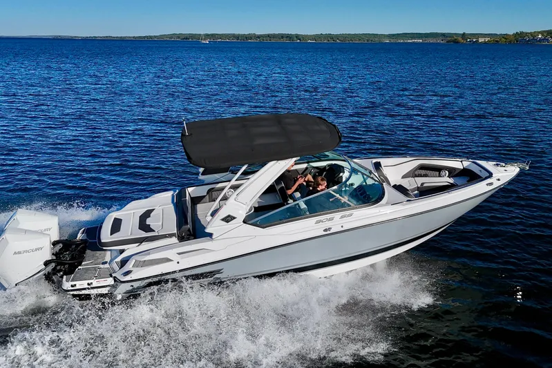  Yacht Photos Pics 2023 Monterey 305SS Super Sport boat cruising on a clear blue lake.