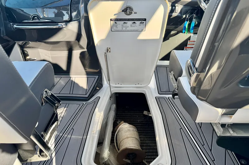  Yacht Photos Pics 2023 Monterey 305SS Super Sport boat interior with open storage compartment.