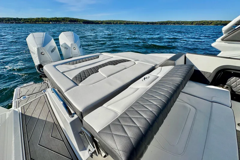  Yacht Photos Pics 2023 Monterey 305SS Super Sport boat with luxurious seating on a sunny lake.