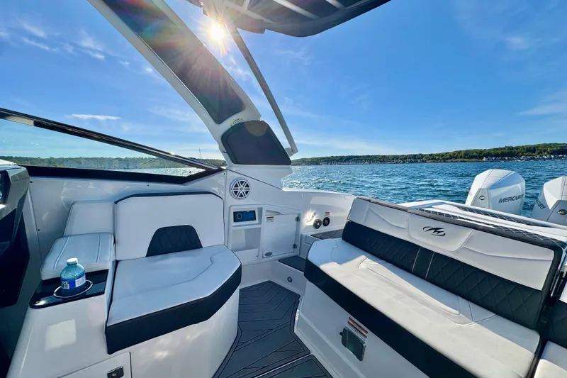  Yacht Photos Pics 2023 Monterey 305SS Super Sport boat interior with luxurious seating on a sunny day.
