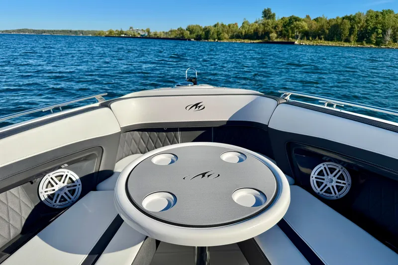  Yacht Photos Pics 2023 Monterey 305SS Super Sport boat interior with table on a sunny lake.