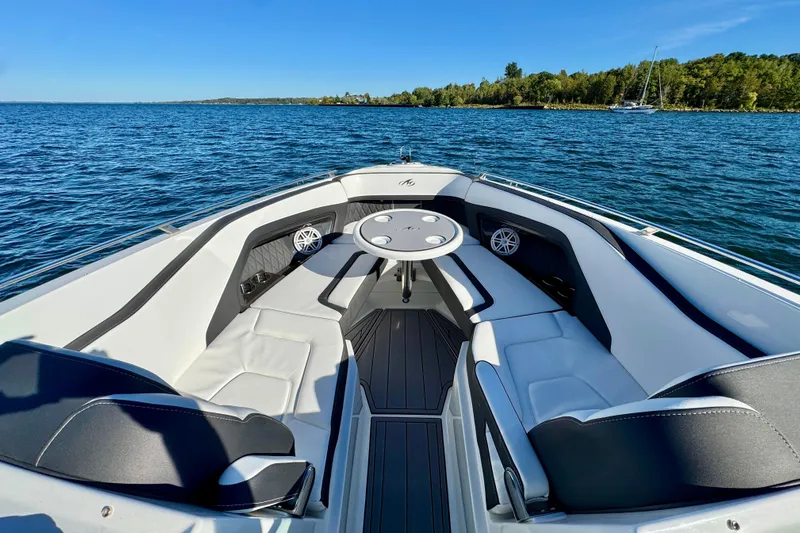  Yacht Photos Pics 2023 Monterey 305SS Super Sport boat interior with seating and table on a sunny lake.