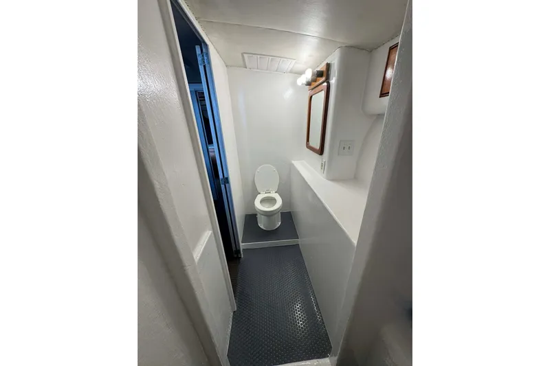  Yacht Photos Pics Compact bathroom interior of 1992 Blackwell Custom Carolina boat, featuring toilet and mirror.