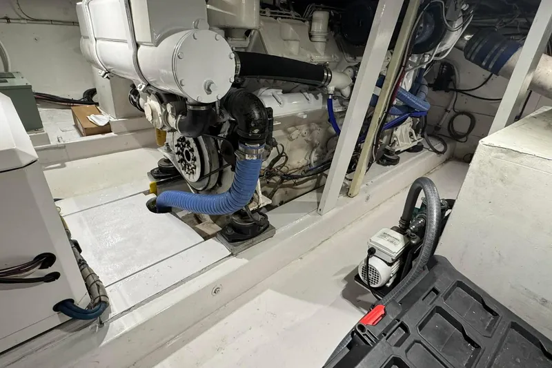  Yacht Photos Pics Engine room of a 1992 Blackwell Custom Carolina boat, showcasing mechanical components and piping.