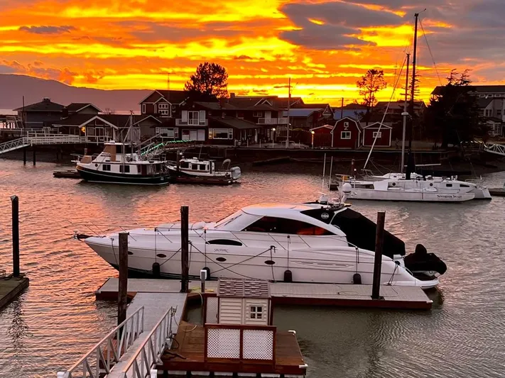  Yacht Photos Pics Luxury 2006 Neptunus 55 Royale yacht docked at sunset, vibrant sky in background.