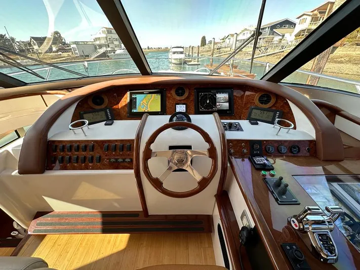  Yacht Photos Pics Helm of 2006 Neptunus 55 Royale yacht with navigation instruments and steering wheel.