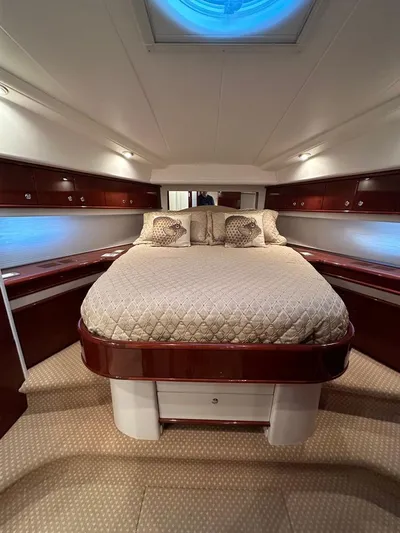  Yacht Photos Pics Luxurious bedroom interior of 2006 Neptunus 55 Royale yacht with elegant bedding and wood finishes.