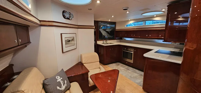  Yacht Photos Pics Luxurious interior of 2006 Neptunus 55 Royale yacht with modern kitchen and seating area.