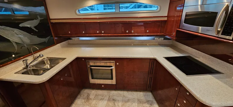  Yacht Photos Pics Luxurious kitchen in 2006 Neptunus 55 Royale yacht with modern appliances and elegant wood cabinetry.