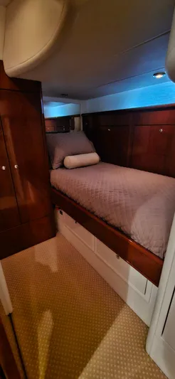  Yacht Photos Pics Luxurious cabin interior of 2006 Neptunus 55 Royale yacht with cozy bed and wooden finish.
