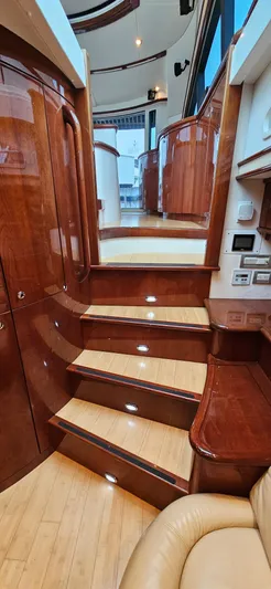  Yacht Photos Pics Luxurious interior staircase of a 2006 Neptunus 55 Royale yacht with polished wood finish.