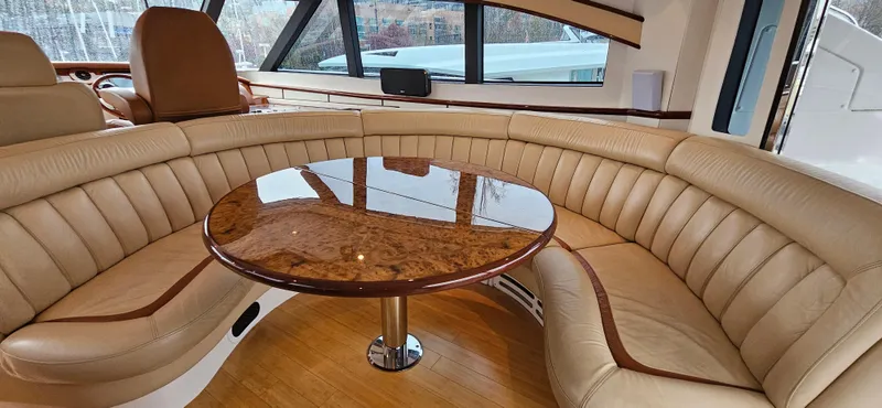  Yacht Photos Pics Luxurious interior of 2006 Neptunus 55 Royale yacht with elegant leather seating and polished wood table.