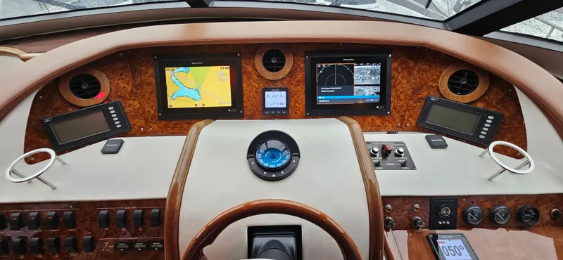  Yacht Photos Pics Cockpit of 2006 Neptunus 55 Royale yacht with navigation screens and controls.