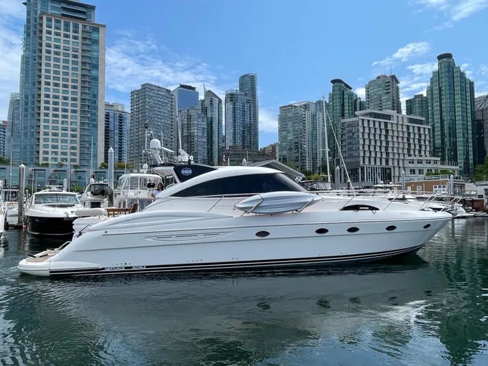  Yacht Photos Pics Luxury 2006 Neptunus 55 Royale yacht docked in urban marina with skyscrapers.