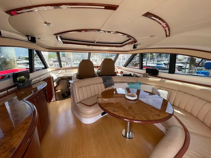  Yacht Photos Pics Luxurious interior of a 2006 Neptunus 55 Royale yacht with elegant seating and wood finishes.
