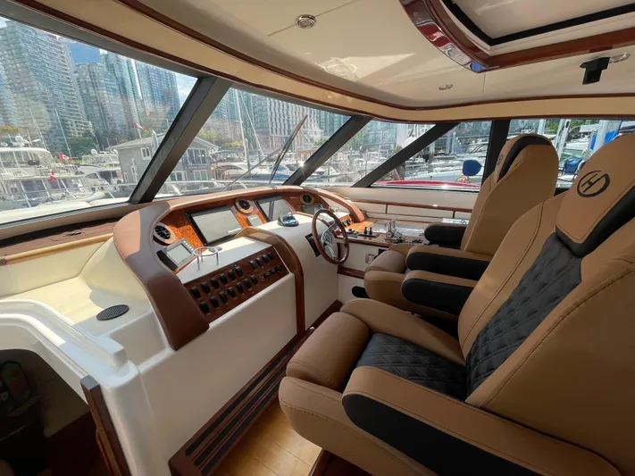  Yacht Photos Pics Luxurious 2006 Neptunus 55 Royale yacht interior with plush seating and modern dashboard.