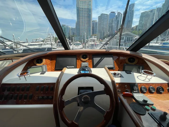  Yacht Photos Pics Helm of 2006 Neptunus 55 Royale yacht with city skyline view.