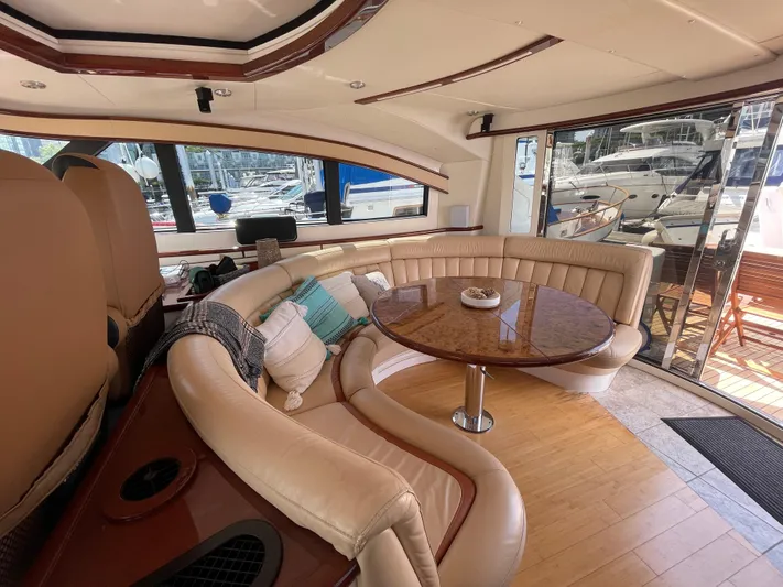  Yacht Photos Pics Luxurious interior of 2006 Neptunus 55 Royale yacht with elegant seating and table.