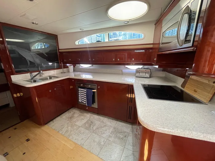  Yacht Photos Pics Luxurious kitchen interior of 2006 Neptunus 55 Royale yacht with modern appliances.