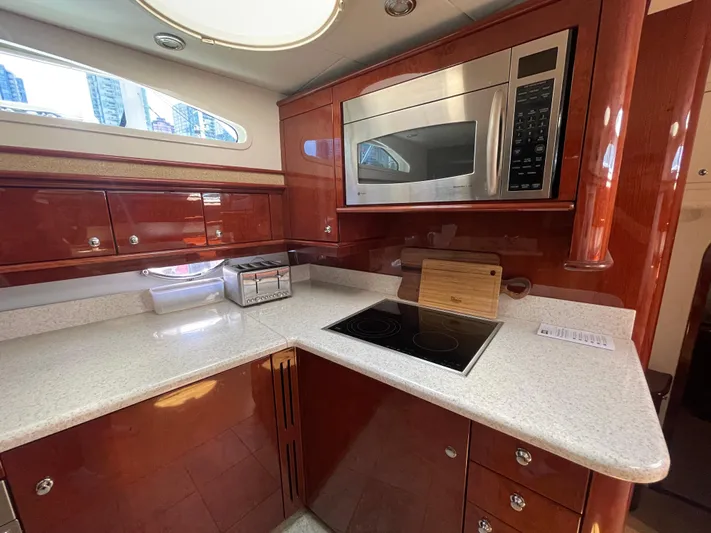  Yacht Photos Pics Luxurious kitchen in 2006 Neptunus 55 Royale yacht with modern appliances and sleek cabinetry.