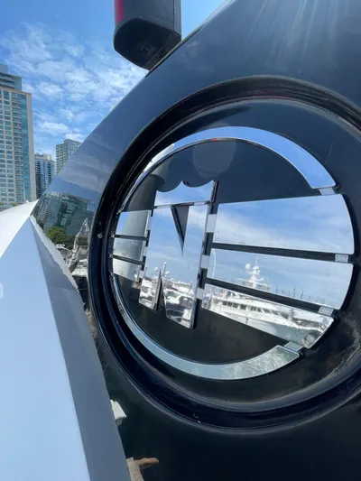  Yacht Photos Pics Close-up of 2006 Neptunus 55 Royale yacht emblem with cityscape background.