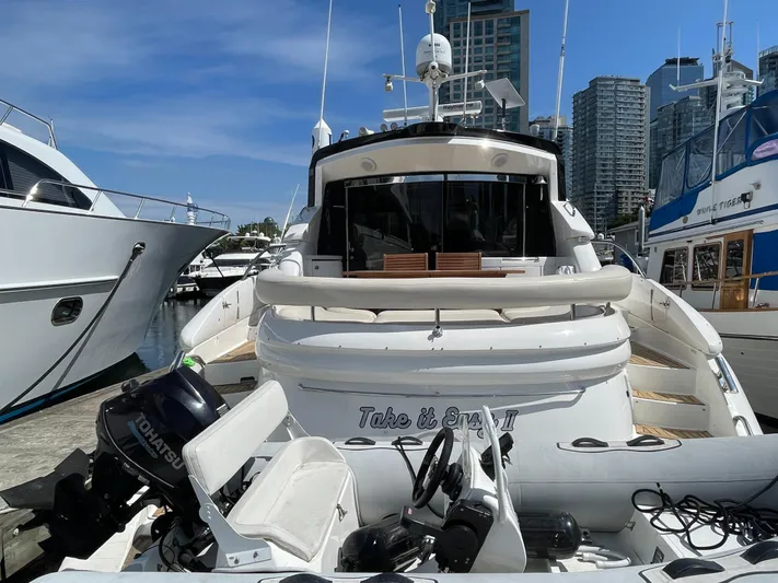  Yacht Photos Pics 2006 Neptunus 55 Royale yacht docked at marina with city skyline backdrop.