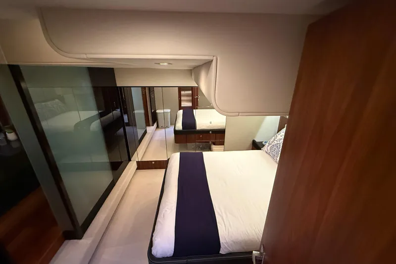 Marckeric Yacht Photos Pics Luxurious bedroom interior of 2012 Fairline Squadron 58 yacht, featuring elegant design and modern amenities.