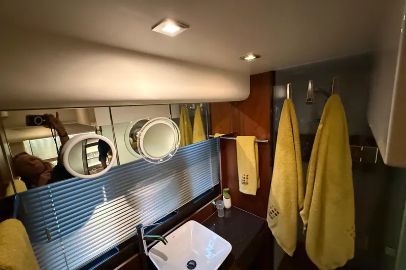 Marckeric Yacht Photos Pics Bathroom interior of 2012 Fairline Squadron 58 yacht with yellow towels and modern fixtures.
