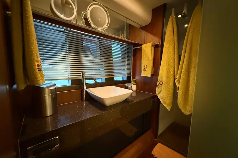 Marckeric Yacht Photos Pics Luxurious bathroom in 2012 Fairline Squadron 58 yacht with modern sink and yellow towels.