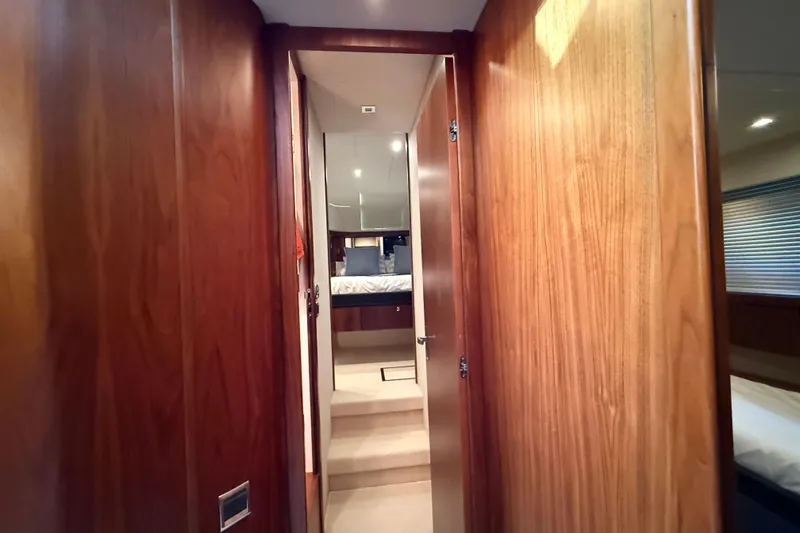 Marckeric Yacht Photos Pics Interior hallway of 2012 Fairline Squadron 58 yacht, featuring wooden paneling and bedroom view.