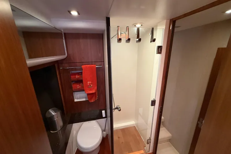 Marckeric Yacht Photos Pics Luxurious bathroom in 2012 Fairline Squadron 58 yacht with modern fixtures and wooden accents.