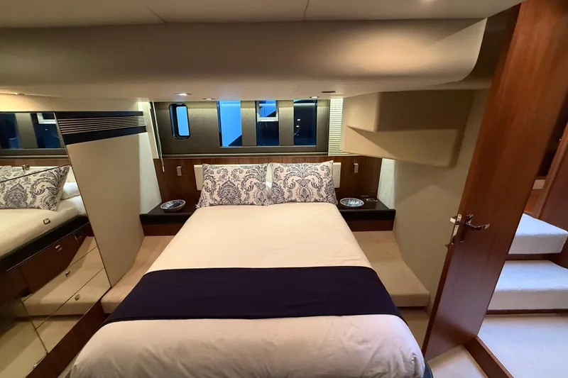 Marckeric Yacht Photos Pics Luxurious bedroom interior of 2012 Fairline Squadron 58 yacht with elegant bedding and wood accents.