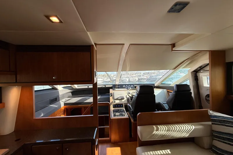 Marckeric Yacht Photos Pics Interior of 2012 Fairline Squadron 58 yacht with modern helm and seating area.