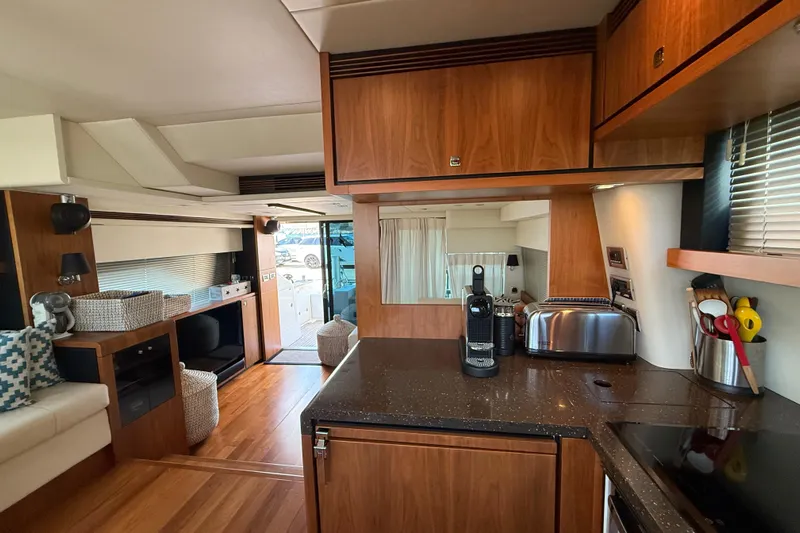 Marckeric Yacht Photos Pics Luxurious interior of 2012 Fairline Squadron 58 yacht with modern kitchen and wooden finishes.