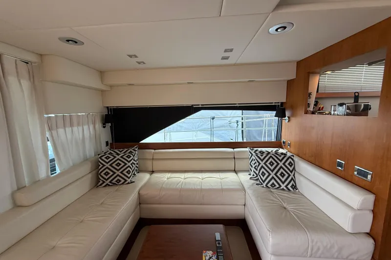 Marckeric Yacht Photos Pics Luxurious interior of 2012 Fairline Squadron 58 yacht with white leather seating.