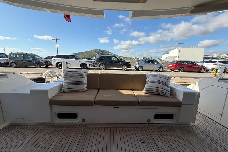 Marckeric Yacht Photos Pics Luxury Fairline Squadron 58 yacht deck with cushioned seating, 2012 model, docked under blue skies.