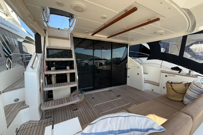 Marckeric Yacht Photos Pics Luxurious 2012 Fairline Squadron 58 yacht interior with wooden stairs and seating area.