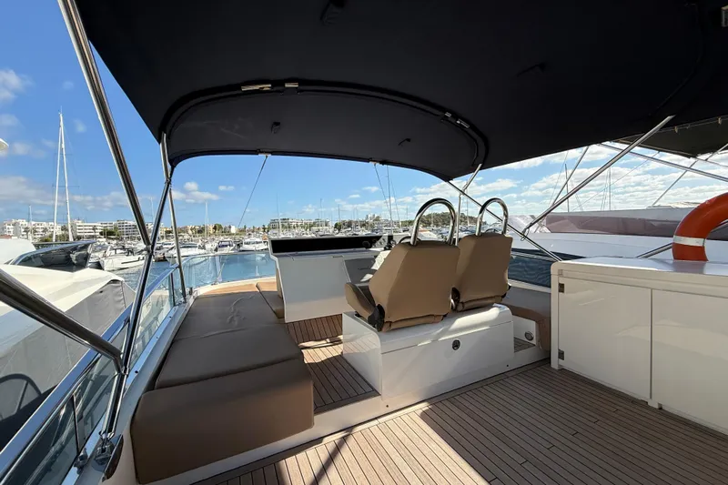 Marckeric Yacht Photos Pics Luxurious 2012 Fairline Squadron 58 yacht interior with seating, docked at a marina.