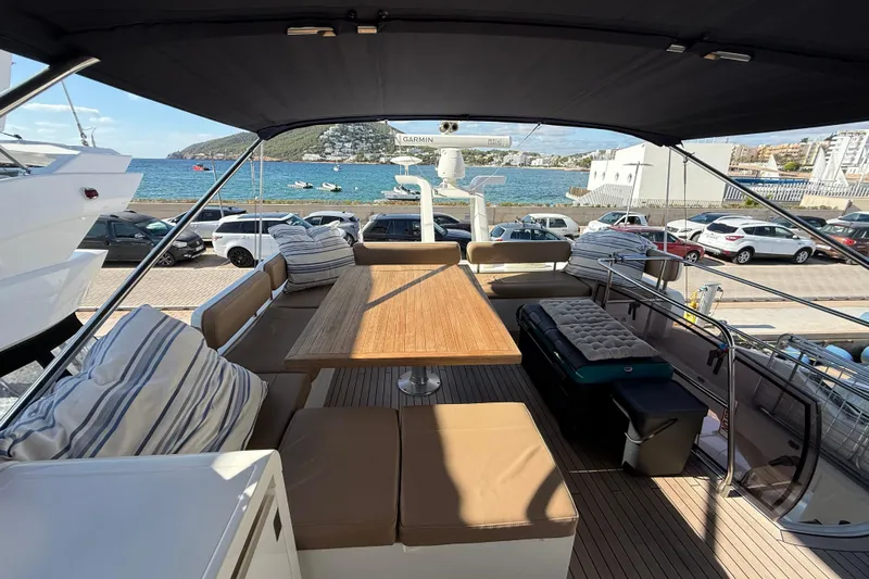 Marckeric Yacht Photos Pics Luxurious 2012 Fairline Squadron 58 yacht deck with seating, table, and ocean view.