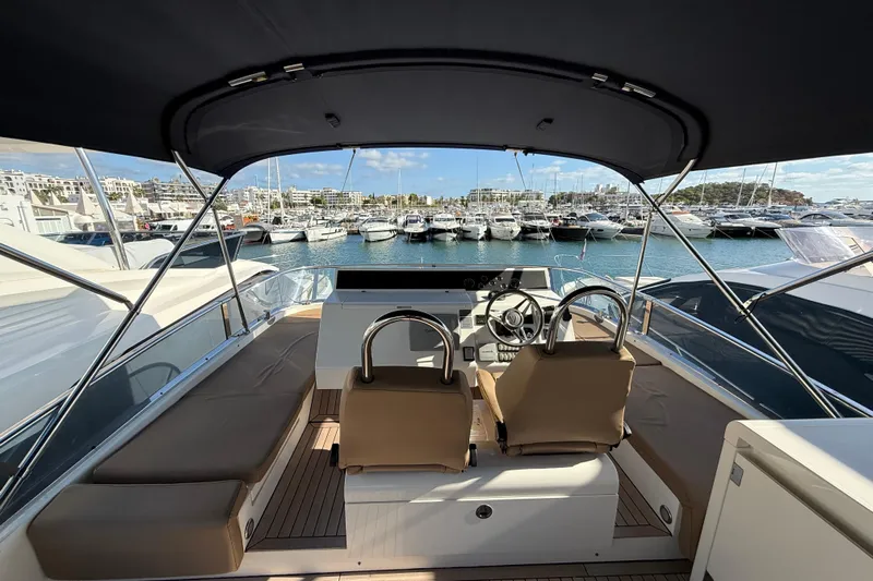 Marckeric Yacht Photos Pics 2012 Fairline Squadron 58 yacht interior with helm, docked in marina.