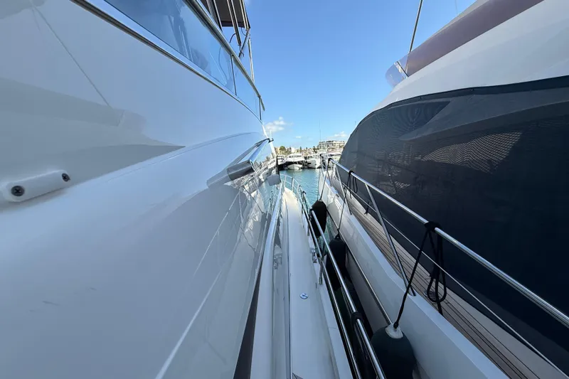 Marckeric Yacht Photos Pics Side view of a 2012 Fairline Squadron 58 yacht docked in a marina.