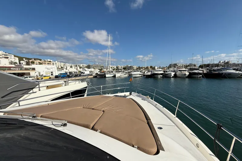 Marckeric Yacht Photos Pics Luxury yacht Fairline Squadron 58, 2012, docked in a sunny marina with clear skies.