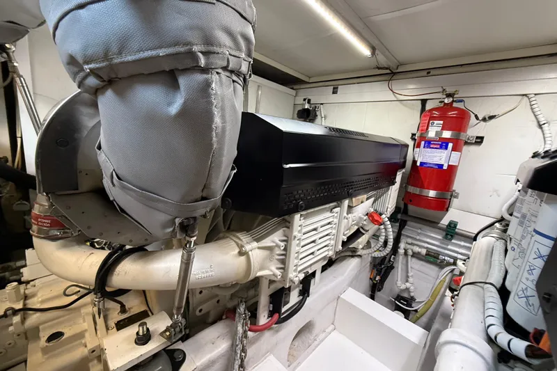 Marckeric Yacht Photos Pics Engine room of 2012 Fairline Squadron 58 yacht with visible machinery and fire extinguisher.